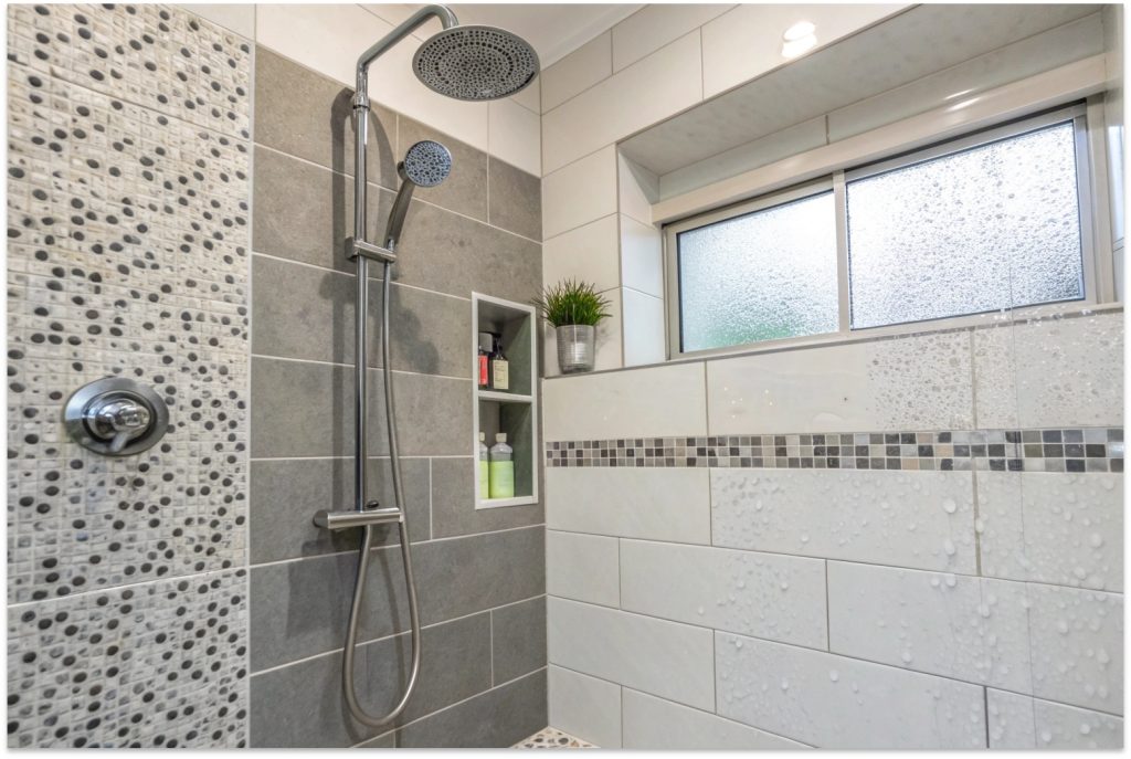Well-maintained bathroom shower tiles after expert tile replacement and repair