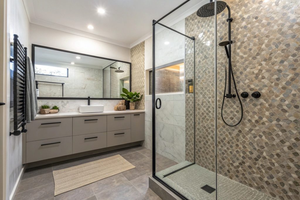 Modern shower tile installation with white tiles and black fixtures in Hobart bathroom